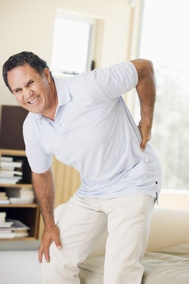a man has back pain in the lumbar region